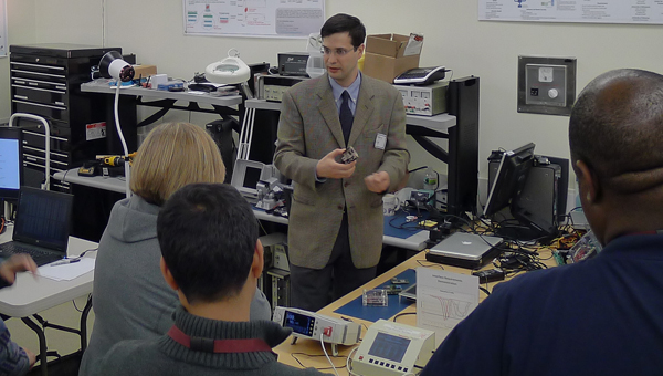 MD PnP lead engineer, Dave Arney, shows device adapters at Lab Open House in October 2012.