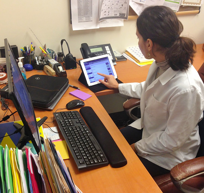 Dorsa Barzin, MSN, RN, care manager at Meritage ACO, checks for updates on one of her patients. Photo is courtesy of Meritage ACO.