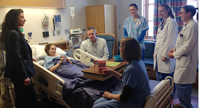 hospital room with patient and family